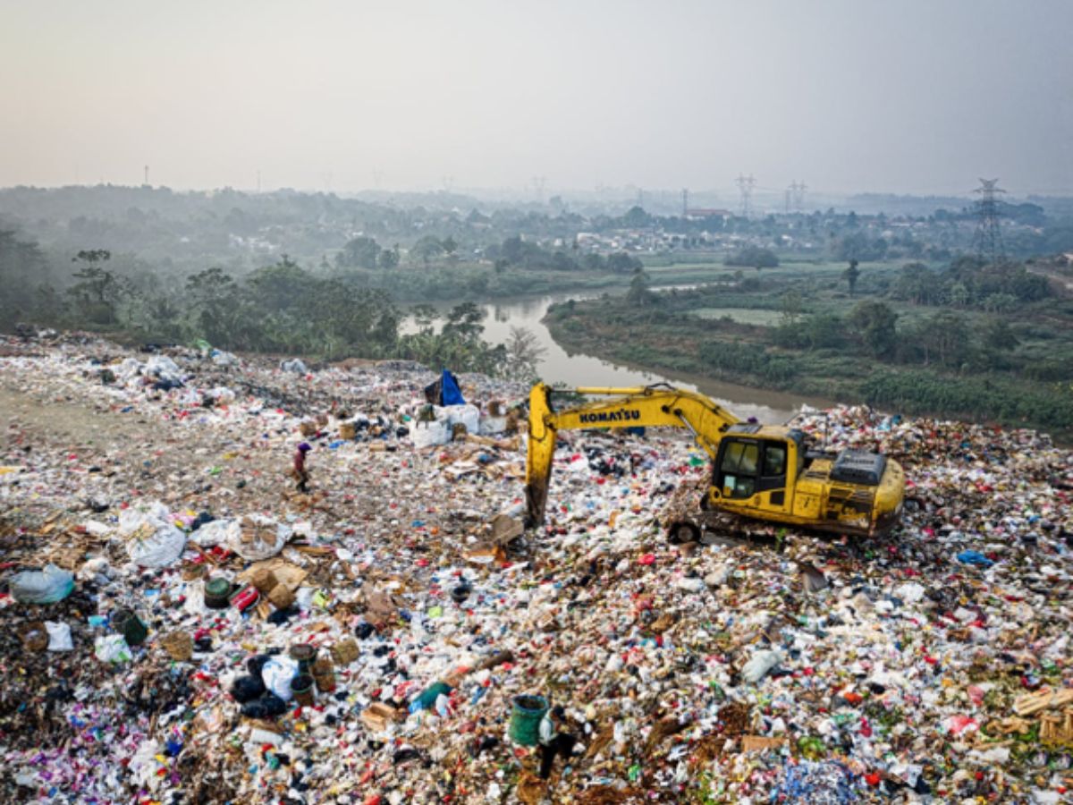 Landfill by a river full of food waste and more
